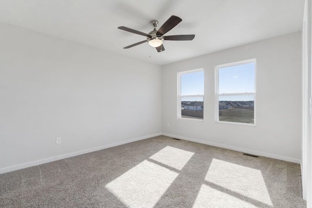 carpeted empty room featuring visible vents and baseboards