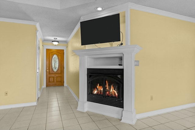 entrance foyer with a warm lit fireplace, a textured ceiling, light tile patterned floors, baseboards, and ornamental molding