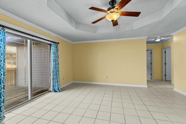 unfurnished room with crown molding, a raised ceiling, light tile patterned flooring, a textured ceiling, and baseboards