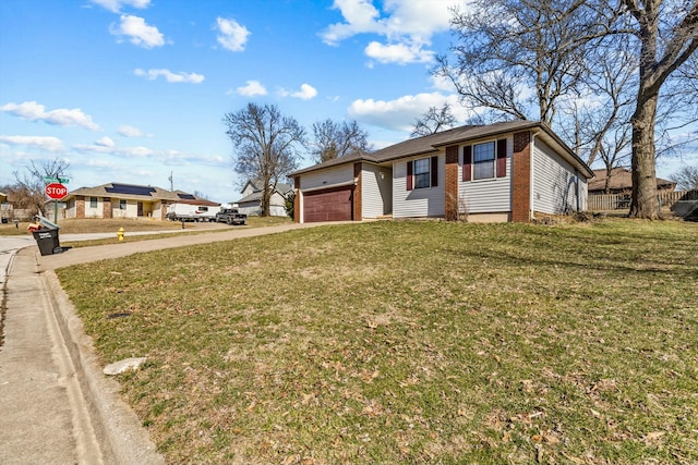 ranch-style home featuring an attached garage, a front yard, concrete driveway, and brick siding