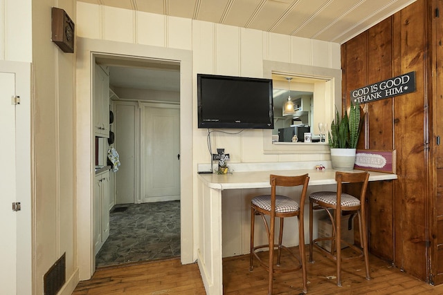 bar with hardwood / wood-style flooring and visible vents