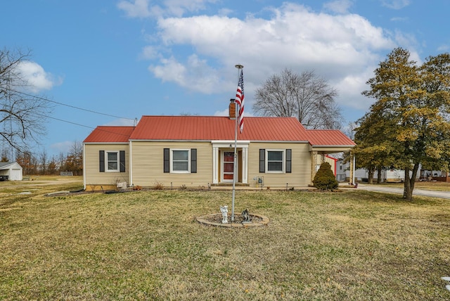 view of front of home featuring metal roof and a front lawn