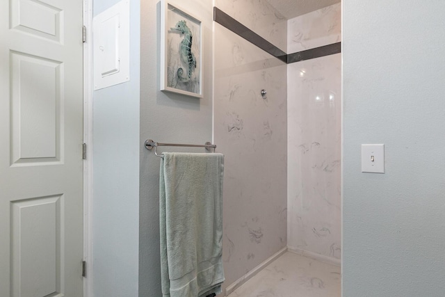 bathroom with baseboards and a shower