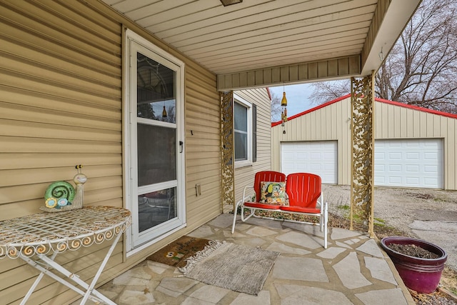 view of patio featuring a garage and an outdoor structure