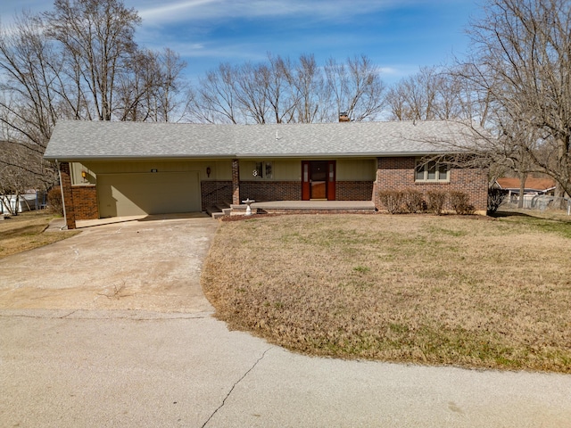 ranch-style home with concrete driveway, brick siding, and a front lawn