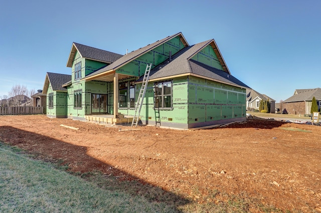 view of front of home with fence and crawl space