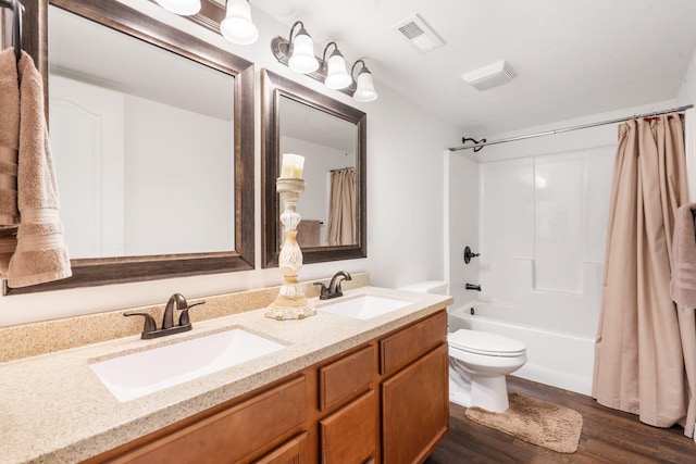 full bathroom featuring double vanity, visible vents, toilet, and a sink