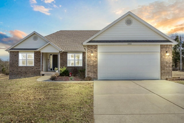 ranch-style home featuring brick siding, a front lawn, concrete driveway, roof with shingles, and an attached garage