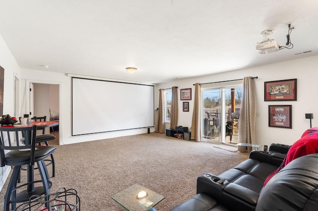 carpeted home theater featuring visible vents