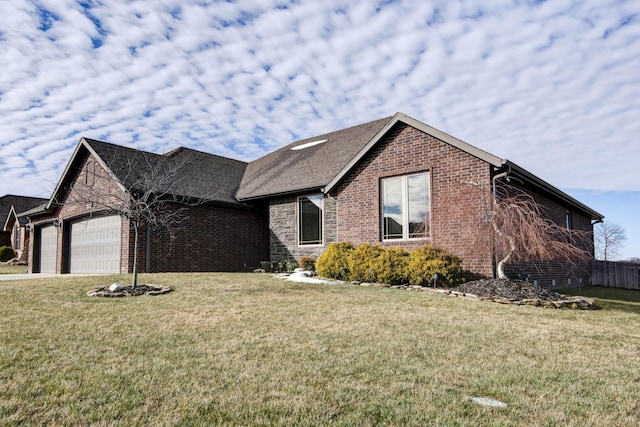 ranch-style home featuring a garage, a front yard, brick siding, and driveway