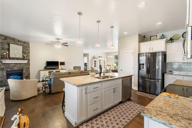 4427 E Kentbrook Dr, Springfield, MO 65802 - kitchen with appliances with stainless steel finishes, a sink, ceiling fan, dark wood-style floors, and white cabinetry