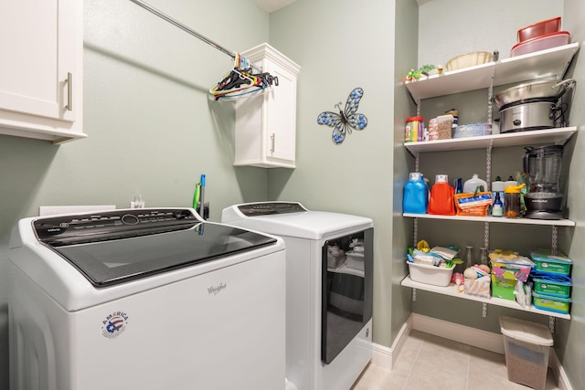 4427 E Kentbrook Dr, Springfield, MO 65802 - laundry room featuring washing machine and dryer, cabinet space, light tile patterned floors, and baseboards