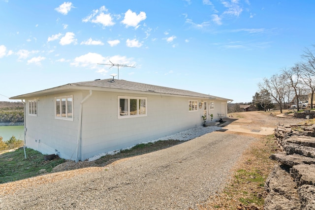 view of side of property with concrete block siding and driveway