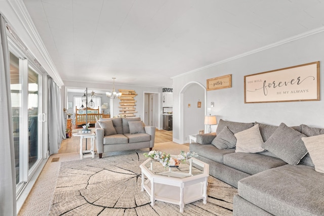 living room with a chandelier, arched walkways, and crown molding