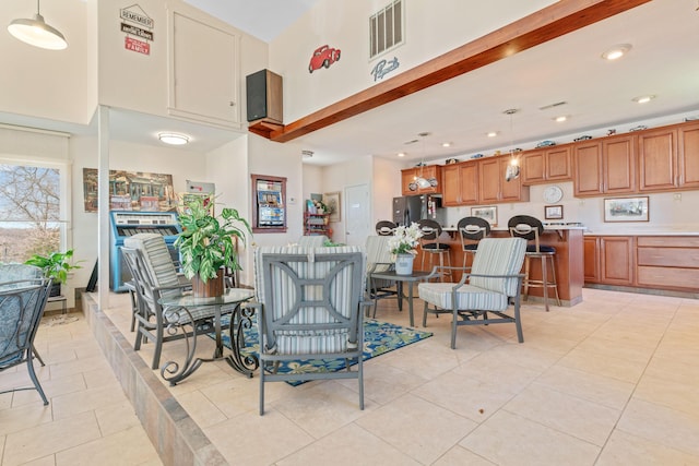 dining room featuring light tile patterned floors, a towering ceiling, visible vents, and recessed lighting