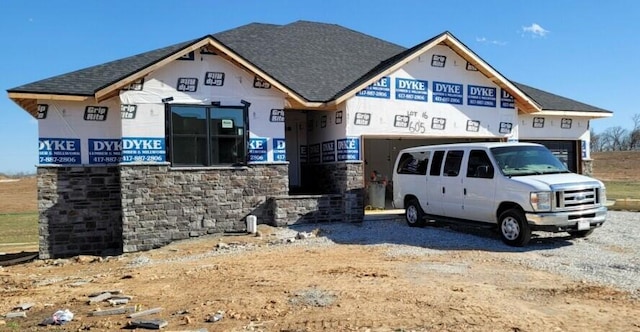 unfinished property featuring a shingled roof