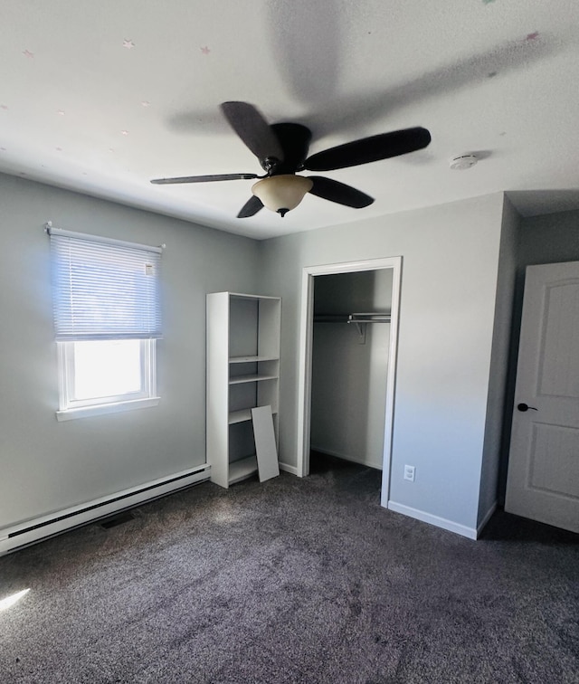 unfurnished bedroom with baseboards, ceiling fan, carpet, baseboard heating, and a closet