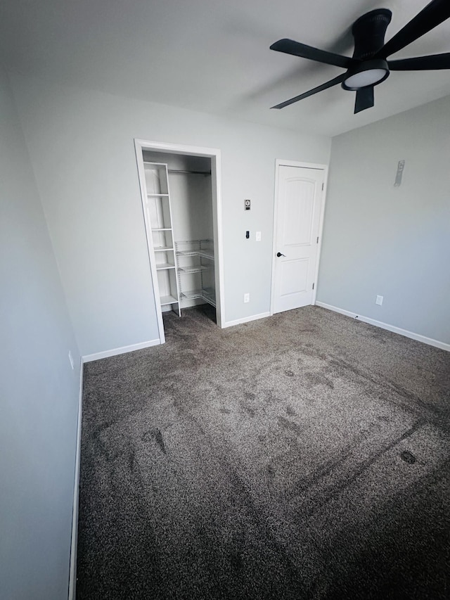 unfurnished bedroom with ceiling fan, a closet, carpet flooring, and baseboards