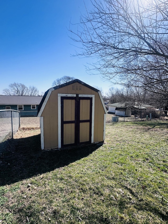 view of shed featuring fence