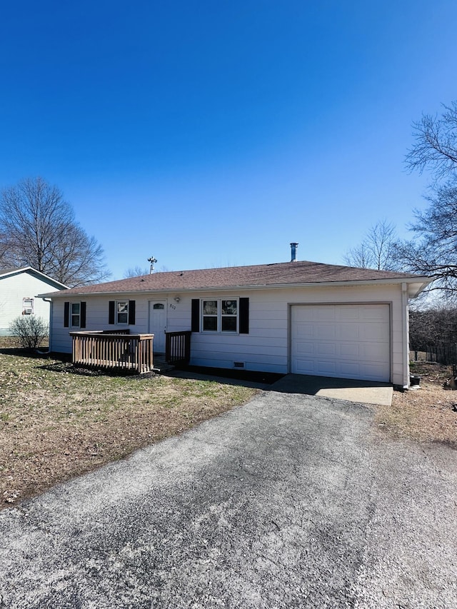 single story home featuring a garage and aphalt driveway