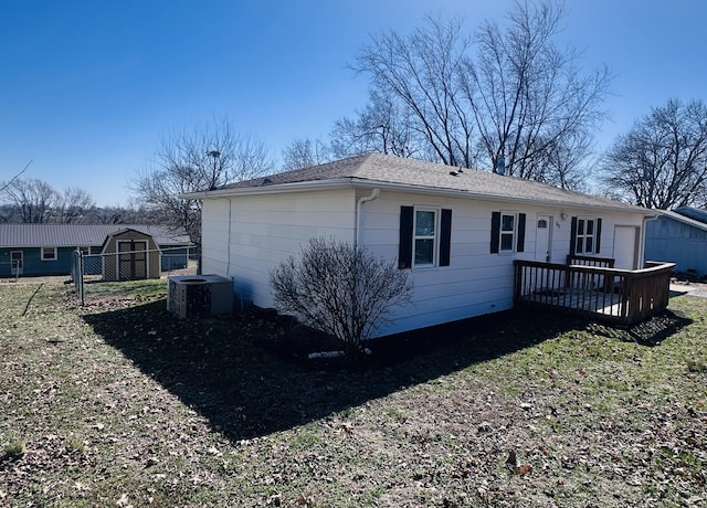 view of home's exterior with an outbuilding, a shed, and central AC unit