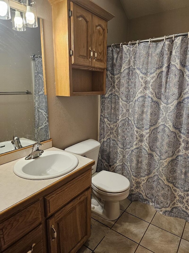 full bathroom featuring a textured wall, curtained shower, tile patterned flooring, toilet, and vanity