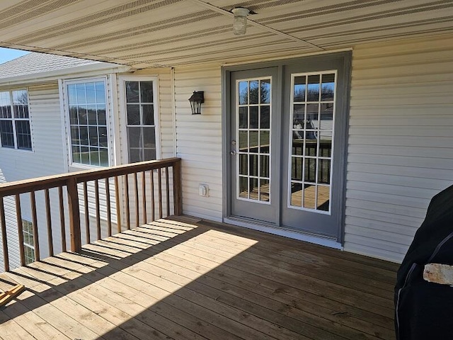 deck with french doors and ceiling fan