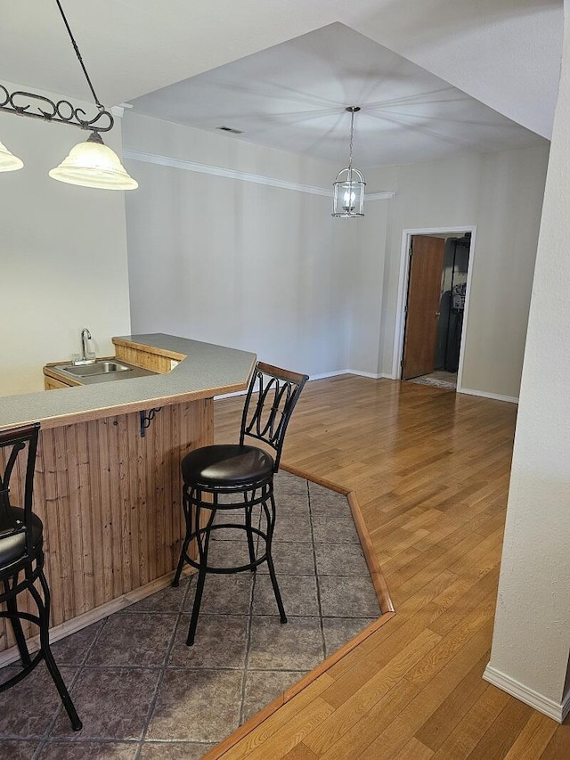 dining area with dark wood-style floors, baseboards, and visible vents