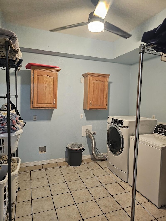 washroom with light tile patterned floors, washer and clothes dryer, cabinet space, and a ceiling fan