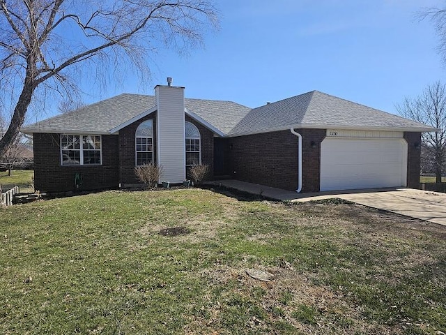 view of home's exterior featuring brick siding, roof with shingles, a chimney, a lawn, and a garage