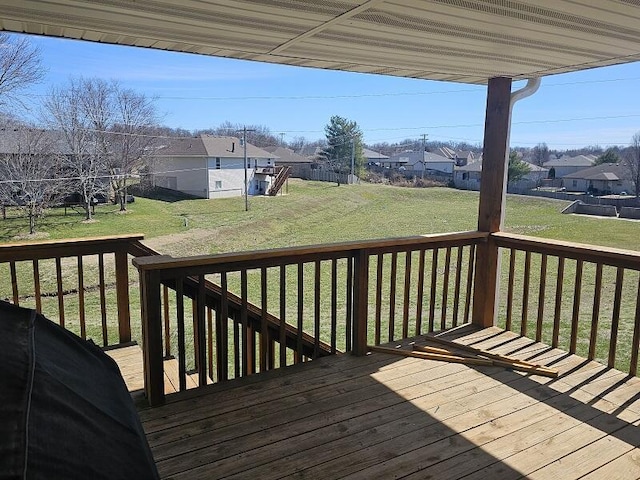 wooden deck with a residential view and a yard