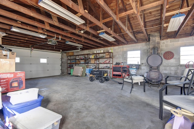 garage with a garage door opener and concrete block wall