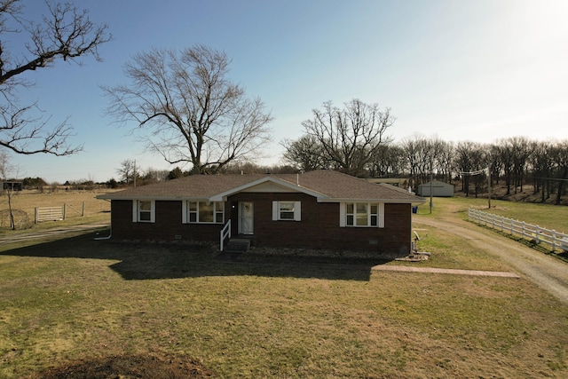 view of front of house featuring a front yard, crawl space, brick siding, and fence