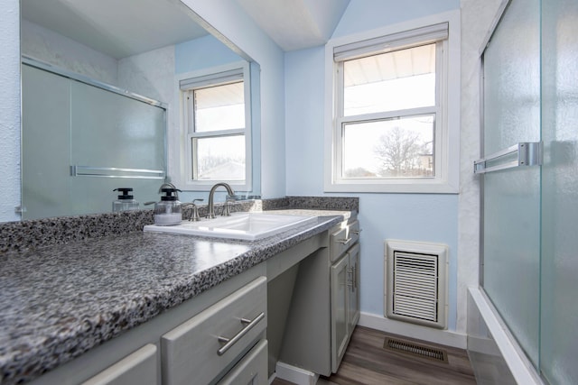 full bath with baseboards, visible vents, wood finished floors, and vanity