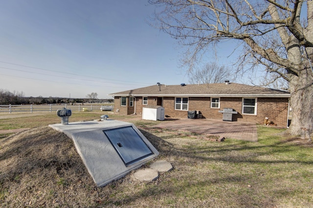 view of storm shelter with fence and a lawn