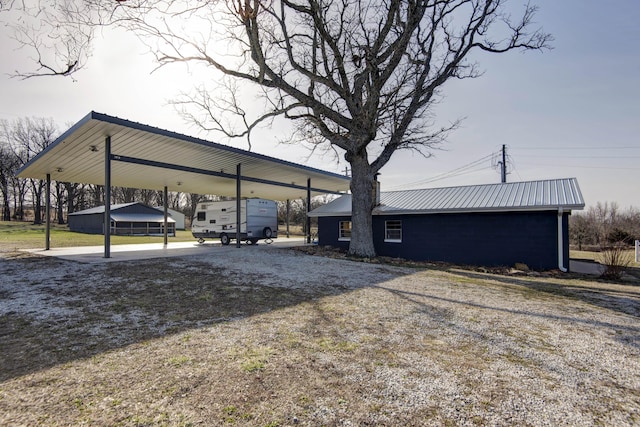 exterior space featuring driveway and a detached carport