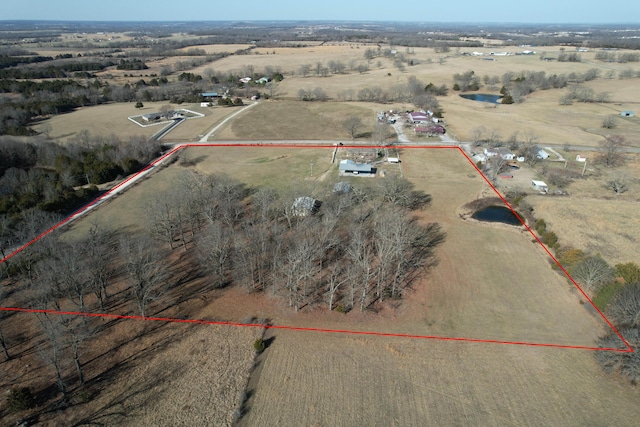 birds eye view of property with a rural view