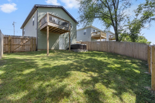 rear view of house featuring a fenced backyard and a yard