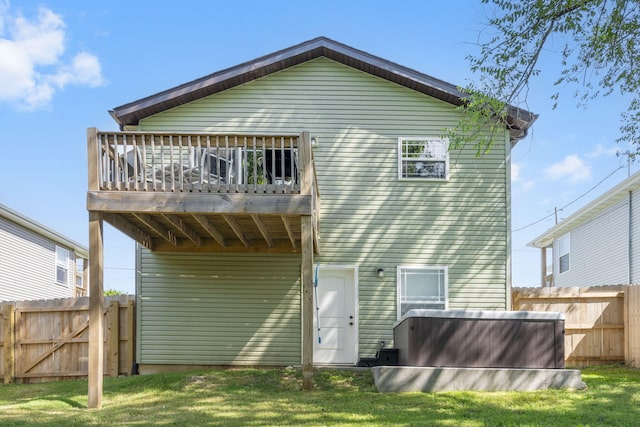 rear view of property featuring fence and a wooden deck