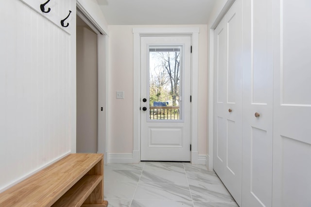 mudroom featuring marble finish floor and baseboards