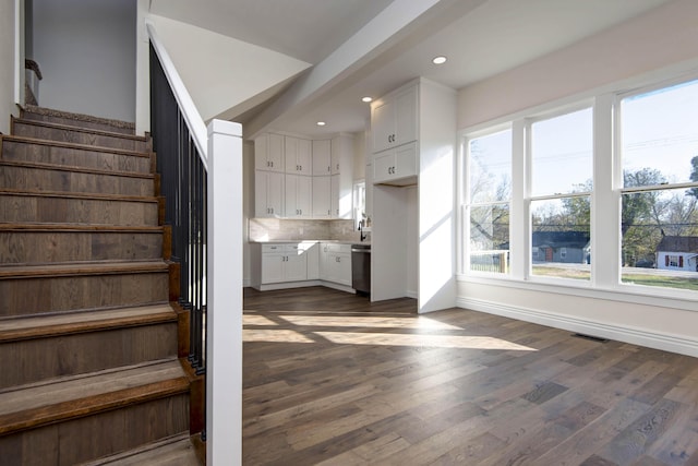 stairs featuring recessed lighting, visible vents, baseboards, and wood finished floors