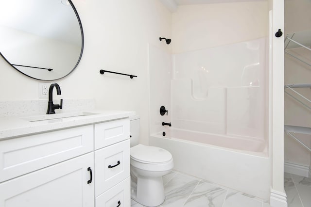 full bathroom featuring marble finish floor, bathing tub / shower combination, toilet, and vanity