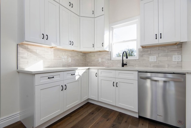 kitchen featuring dishwasher, light countertops, white cabinets, and decorative backsplash