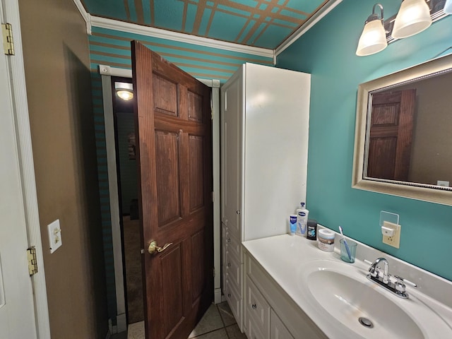 bathroom with tile patterned floors, crown molding, and vanity