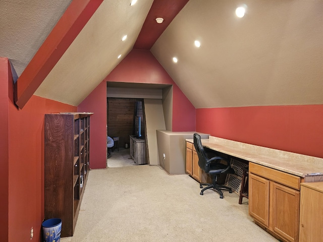 office featuring lofted ceiling, recessed lighting, light carpet, and built in study area