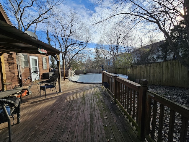 deck featuring a fenced in pool and a fenced backyard