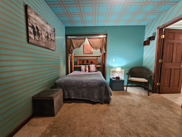 carpeted bedroom with baseboards and wallpapered walls