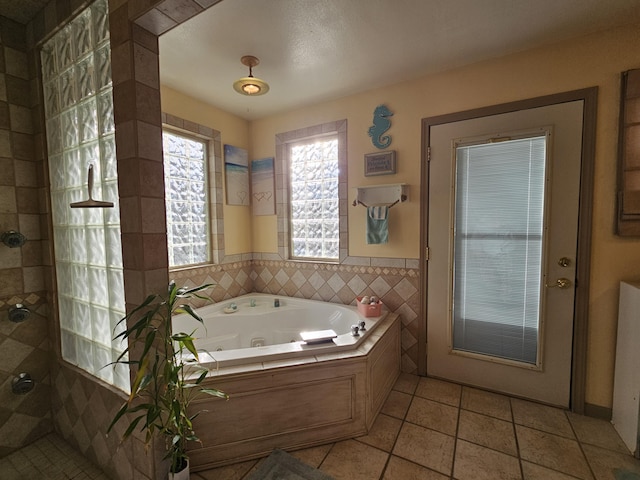 full bath with tile patterned flooring, tiled shower, and a whirlpool tub