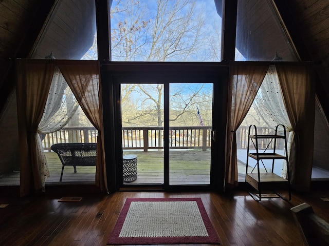 doorway to outside with high vaulted ceiling, wood-type flooring, and visible vents