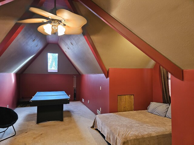 carpeted bedroom with lofted ceiling, a textured ceiling, and a ceiling fan